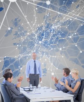 Business people applauding during meeting  against background with europa map