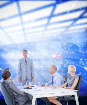 Business people listening during meeting  against world map with stocks figures