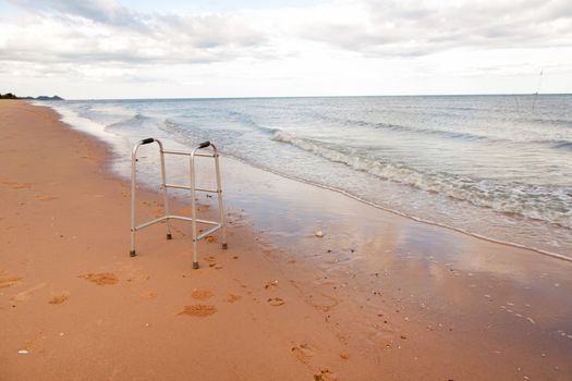 walker on sand beach. convey in meaning the relax tourist attractions of the elderly.