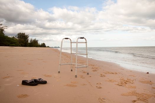 walker on sand beach. convey in meaning the relax tourist attractions of the elderly.