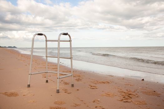 walker on sand beach. convey in meaning the relax tourist attractions of the elderly.