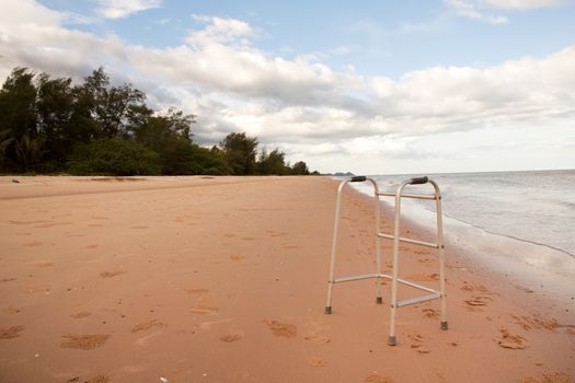 walker on sand beach. convey in meaning the relax tourist attractions of the elderly.