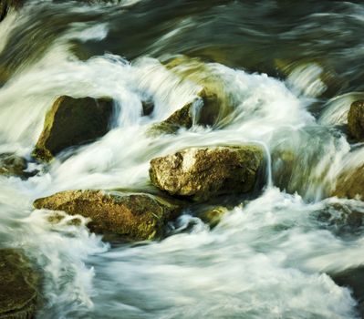 wild mountain stream running between rocks