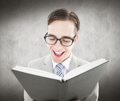 Geeky preacher reading from black bible against white and grey background