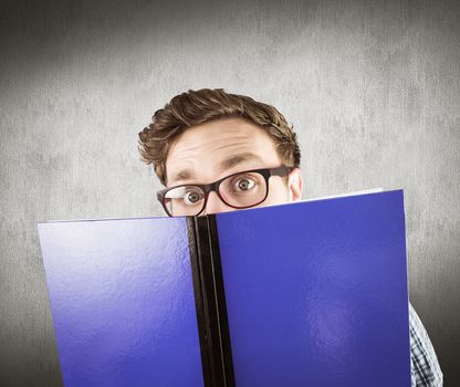 Geeky student reading a book against white and grey background