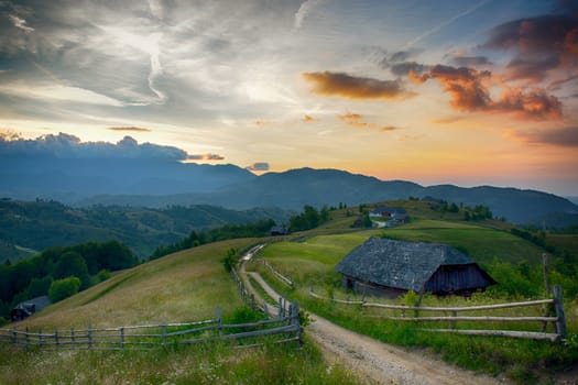 Evening, sunset on mountain hills of Simon village. Bran.