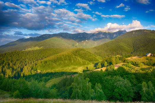 Evening, sunset on mountain hills of Simon village. Bran.