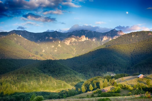 Evening, sunset on mountain hills of Simon village. Bran.