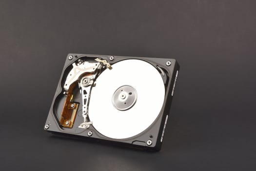 opened SATA hard drive,  on dark background