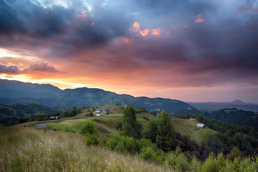 Evening, sunset on mountain hills of Simon village. Bran.