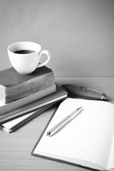 open book with coffee cup on wood background black and white color tone style