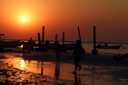 A kid running by the sunset.it is never too late to chase your dreams.