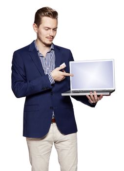 Young businessman is showing something on a computer. Isolated on white background.