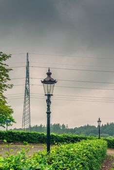 Lamp and pylons in cloudy weather