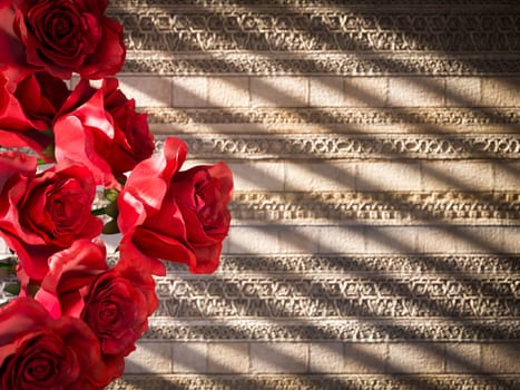 red roses on ancient wall decorative concept background