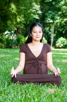 Pregnant woman sitting in the park . in anticipation of the child. Senses of tenderness, love and motherhood. toned photo