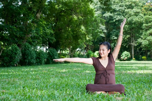 Pregnant woman sitting in the park . in anticipation of the child. Senses of tenderness, love and motherhood. toned photo