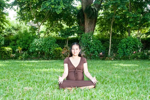 Pregnant woman sitting in the park . in anticipation of the child. Senses of tenderness, love and motherhood. toned photo