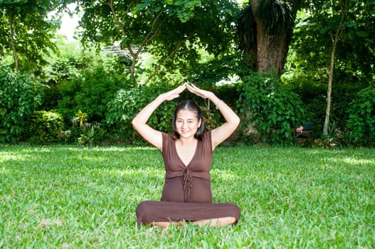 Pregnant woman sitting in the park . in anticipation of the child. Senses of tenderness, love and motherhood. toned photo