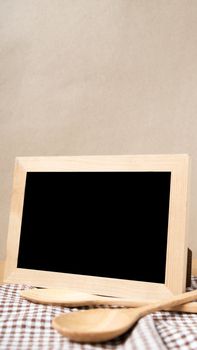 blackboard and wooden spoon on table