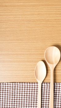 wood spoon and kitchen towel on table