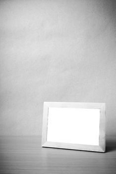 picture frame on wood table background black and white color tone style