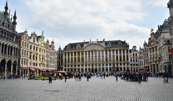 Brussels, Belgium - May 12, 2015: Tourists visiting famous Grand Place of Brussels.