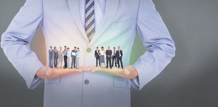 Business team looking at camera against grey background