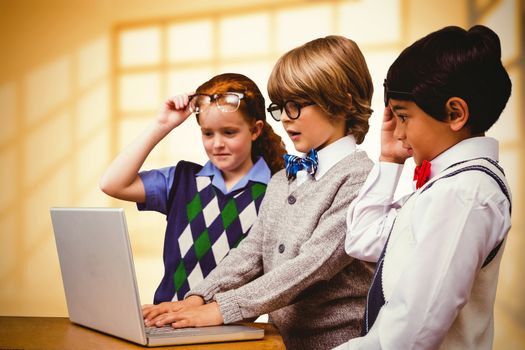 Pupils using laptop against room with large windows showing city