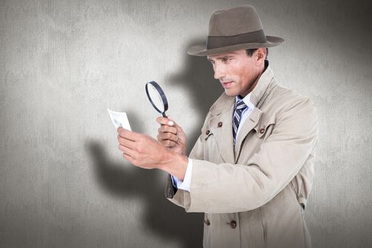 Spy looking through magnifier against white and grey background