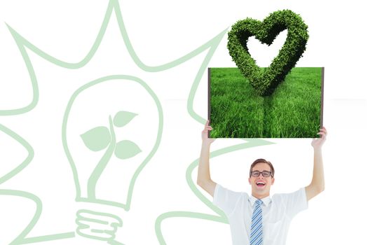 Man holding up lawn book against heart made of leaves