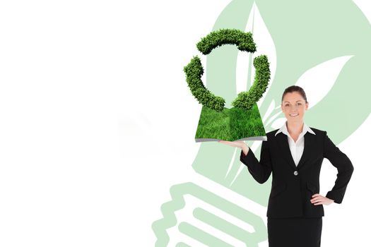 Woman holding lawn book against recycling symbol made of leaves