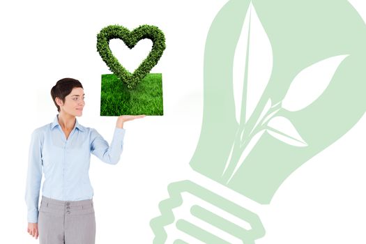 Woman holding lawn book against heart made of leaves