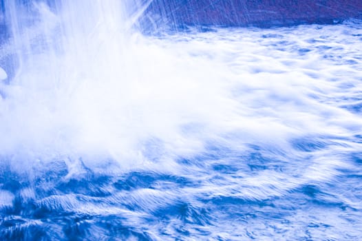 Nature conceptual image. Motion picture of fresh, blue water in waterfall.