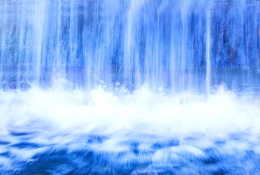 Nature conceptual image. Motion picture of fresh, blue water in waterfall.