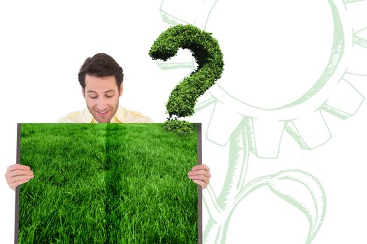 Man holding lawn book against question mark made of leaves