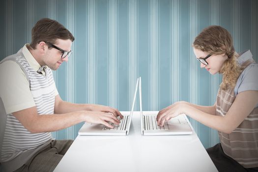 Geeky hipster couple using laptop against background