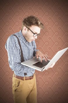 Geeky businessman using his laptop against background
