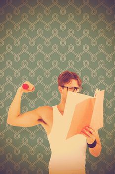 Geeky hipster lifting dumbbells and reading notepad  against blue background