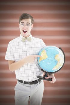 Geeky hipster holding a globe smiling at camera against background