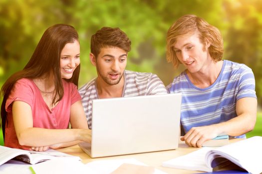 College students using laptop in library against trees and meadow