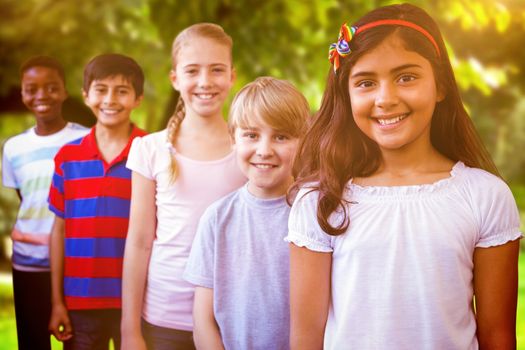 Smiling little school kids in school corridor against trees and meadow in the park