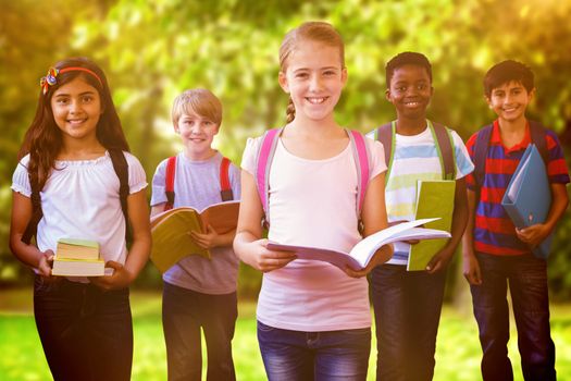 Smiling little school kids in school corridor against trees and meadow in the park