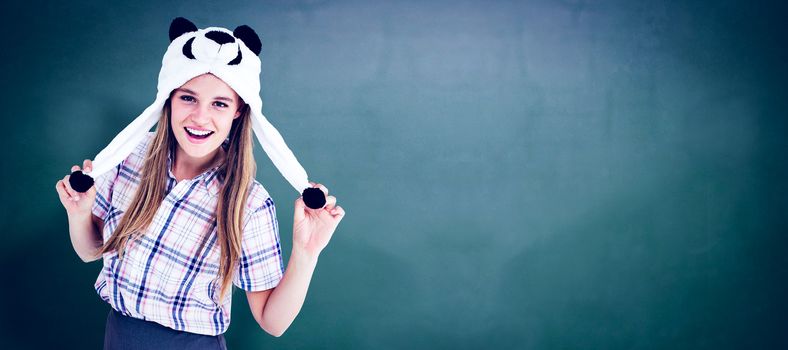 Geeky hipster smiling at camera  against green chalkboard