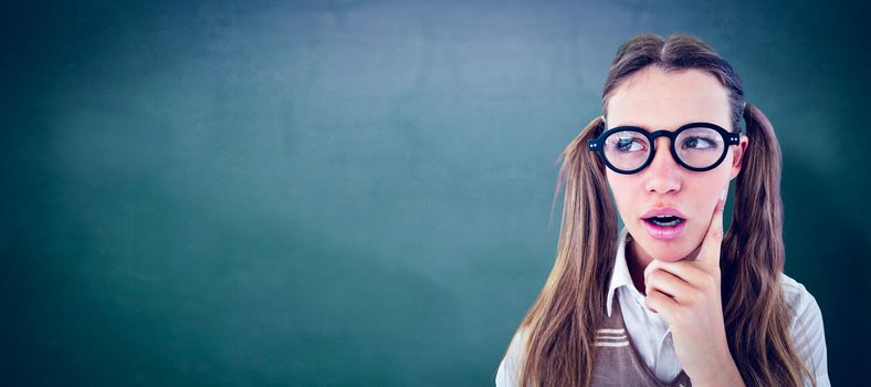 Female geeky hipster looking confused  against green chalkboard