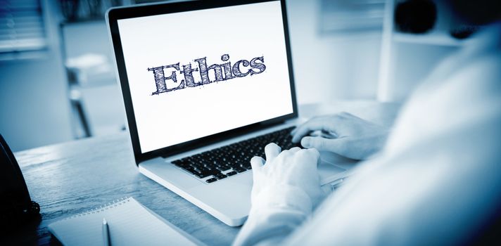 The word ethics against businessman working on his laptop