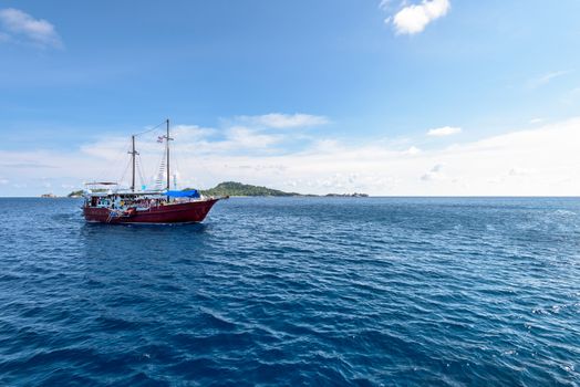 Large passenger ship traveling on the blue water of the Andaman Sea in summer at Mu Koh Similan island National Park, Phang Nga Province, Thailand