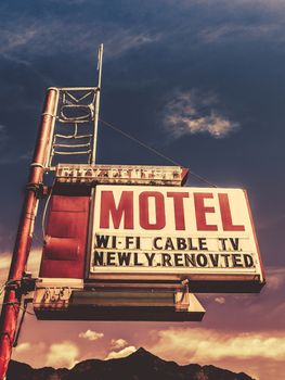Retro Vintage Image Of Old Motel Sign In Small Town USA In The Mountains