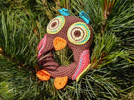 knitted owl as decoration on Christmas tree