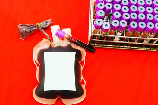 Close up bag of blood and plasma and rubber tube isolated on Red background